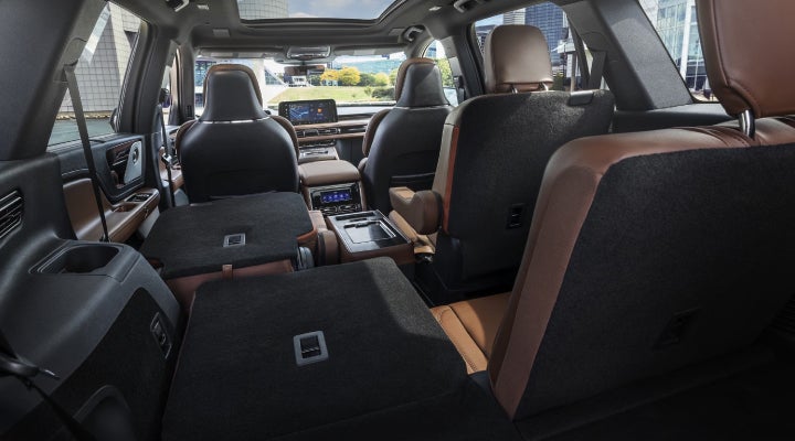 One side of the PowerFold® third-row seat and a second-row seat are folded forward in the 2026 Lincoln Aviator® SUV. | Green Lincoln in Greensboro NC