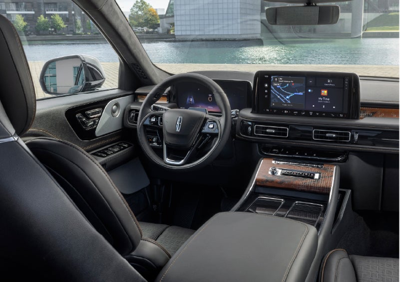 The interior of the 2026 Lincoln Aviator® SUV is shown parked with a view of a harbor through the windshield. | Green Lincoln in Greensboro NC