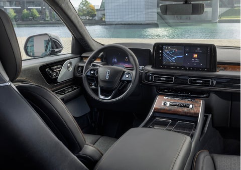 The interior of the 2026 Lincoln Aviator® SUV is shown parked with a view of a harbor through the windshield. | Green Lincoln in Greensboro NC