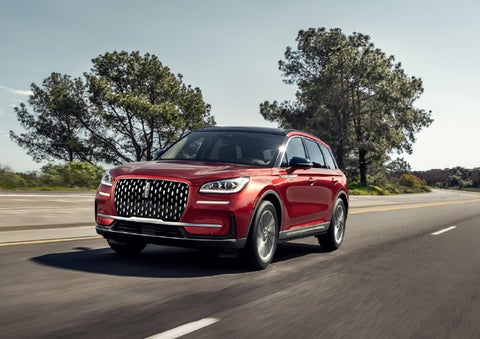 A 2026 Lincoln Corsair® SUV is shown being driven on a country road. | Green Lincoln in Greensboro NC