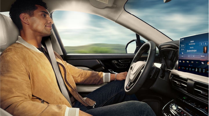 A person is shown using Lincoln BlueCruise hands-free highway driving technology on a divided highway in a hands-free Blue Zone. | Green Lincoln in Greensboro NC
