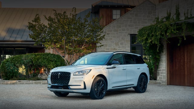 A 2026 Lincoln Corsair® SUV is parked in front off a luxury home. | Green Lincoln in Greensboro NC