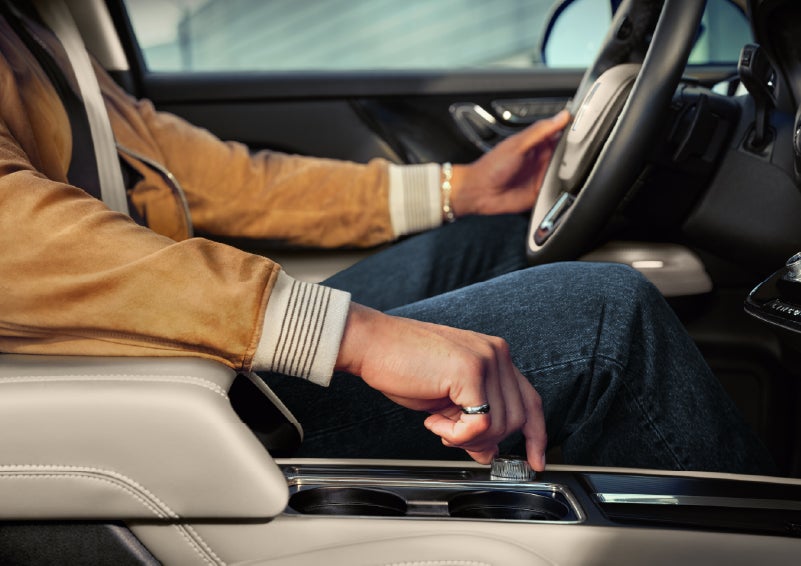 The driver of a 2026 Lincoln Corsair® SUV is shown selecting a drive mode. | Green Lincoln in Greensboro NC