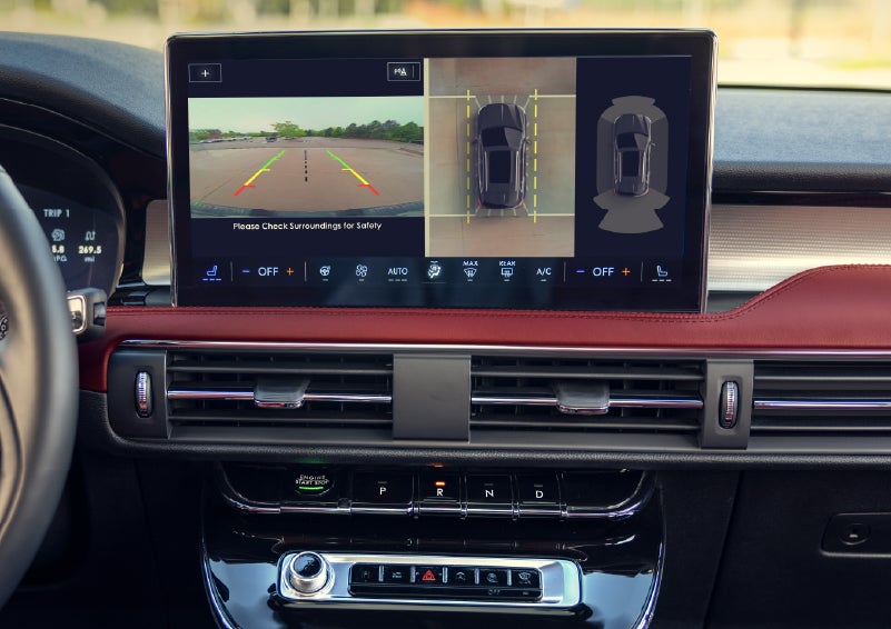 A couple approaches a 2026 Lincoln Corsair® Reserve model as the Lincoln Embrace illumination guides the way | Green Lincoln in Greensboro NC