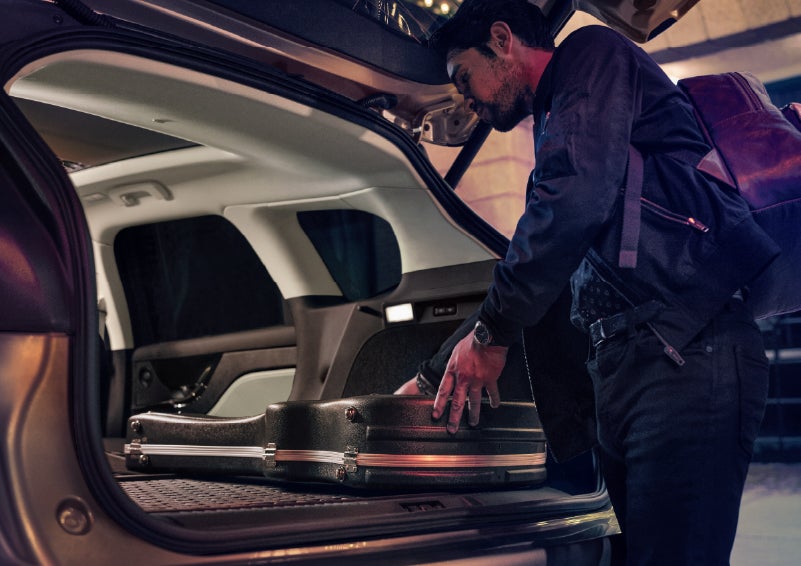 A man is shown loading cargo into the rear of a 2026 Lincoln Corsair® SUV with the second-row seats folded flat. | Green Lincoln in Greensboro NC