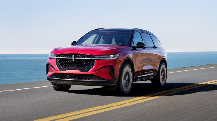 A 2026 Lincoln Nautilus® SUV is being driven on a seaside roadway. | Green Lincoln in Greensboro NC