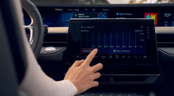 A woman is shown using the Auto Air Refresh feature in the 2026 Lincoln Nautilus® SUV. | Green Lincoln in Greensboro NC