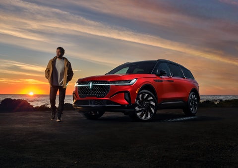 A person is shown next to a 2026 Lincoln Nautilus® SUV as the Lincoln Embrace sequence takes place. | Green Lincoln in Greensboro NC