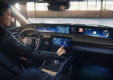 The driver of a 2026 Lincoln Nautilus® SUV interacts with the center touchscreen. | Green Lincoln in Greensboro NC