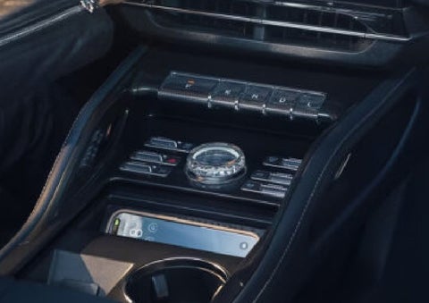 A smartphone is shown charging in the wireless charging pad. | Green Lincoln in Greensboro NC