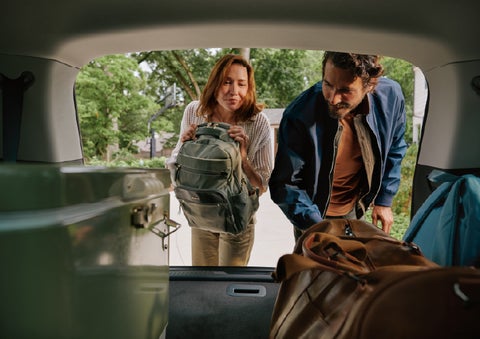 A couple loads luggage into the rear of a 2027 Lincoln Aviator® Black Label™ SUV..e 202 | Green Lincoln in Greensboro NC